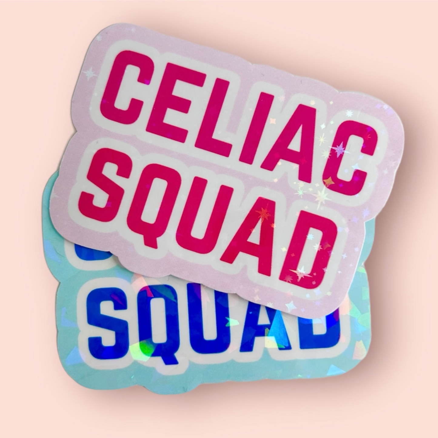 Pink and blue “Celiac Squad” stickers stacked on a light pink background.