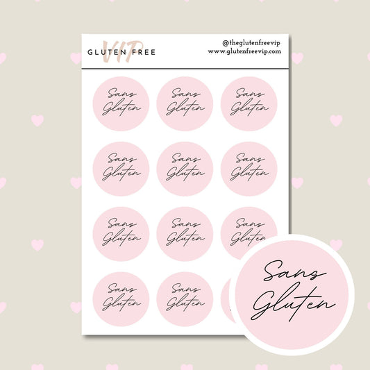 Sheet of pink round “Sans Gluten” labels with script lettering.