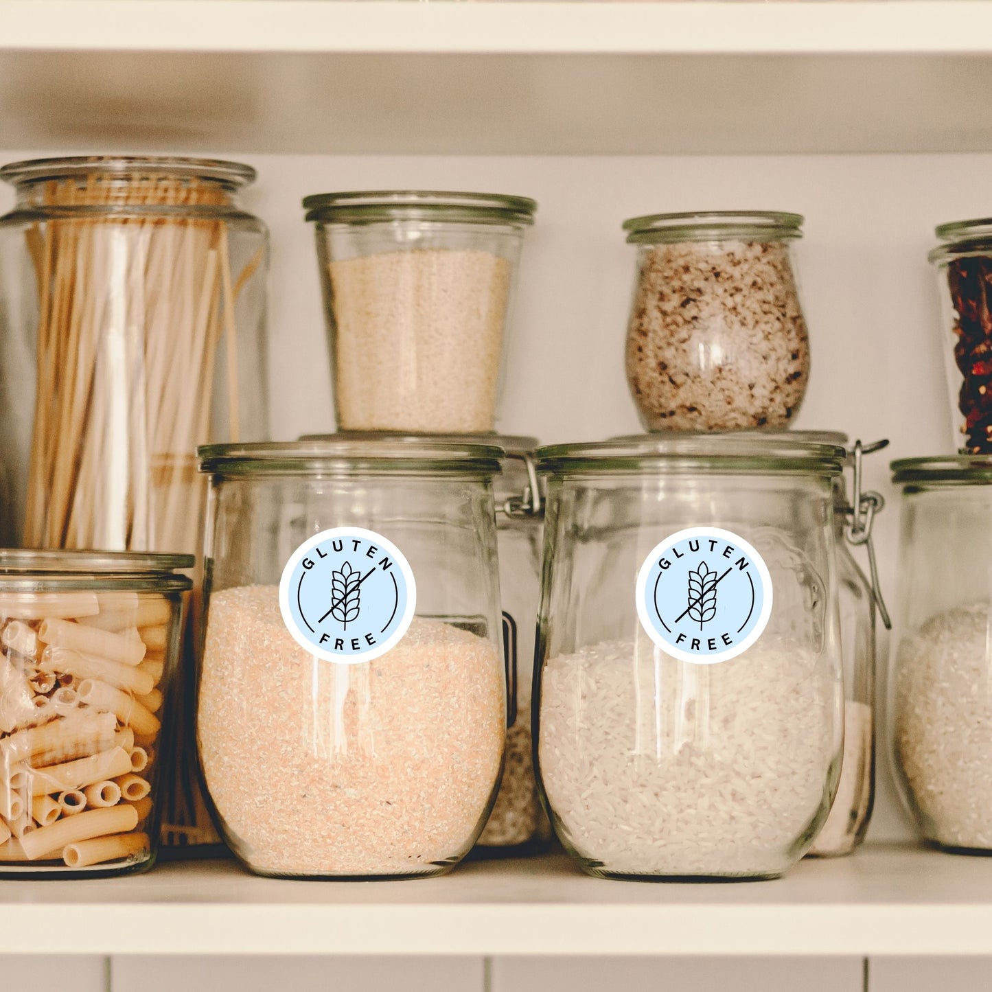 Gluten Free pantry labels on jars filled with pasta, flour, and oats.